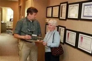 Dr. Kinsley talking with a patient in the corridor.