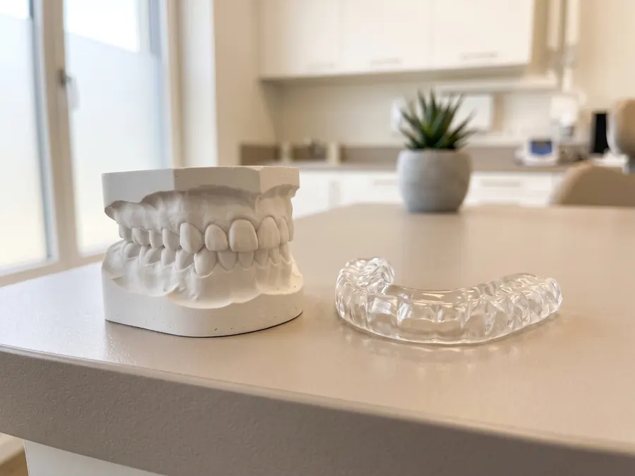 A clear custom night guard, the kind of appliance used to protect teeth from grinding.
